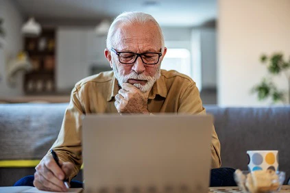 Retired Man Working Out Finances At Home