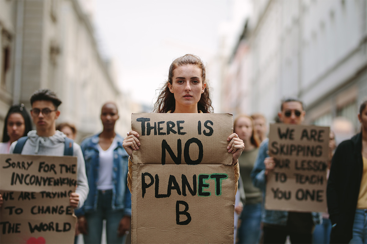 Protestor holding a banner with the words 'There is no planet B'